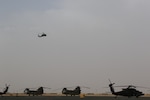 A UH-60 Black Hawk helicopter, operated by Soldiers with the 28th Expeditionary Combat Aviation Brigade, flies over an airfield in the 28th ECAB's area of operations in the Middle East.