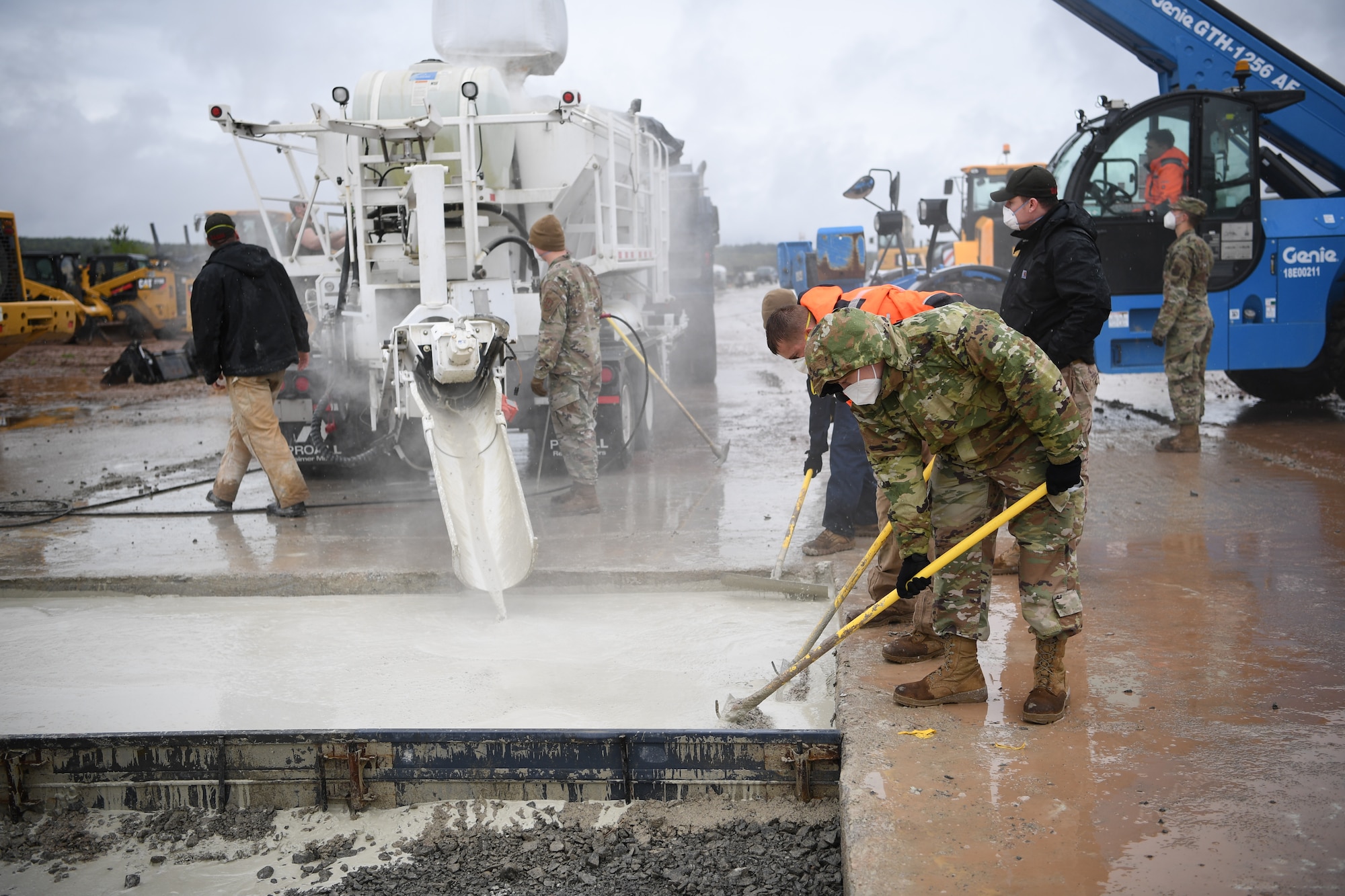 U.S. Air Force airmen smooth concrete as it's poured at Ramstein Air Base, Germany, May 11, 2021. Agile Combat Employment ensures U.S. Air Forces in Europe, along with allies and partners, are ready for potential short or no-notice contingencies by allowing forces to operate from locations with varying levels of capacity and support. This ensures Airmen and aircrews are postured to respond across a spectrum of military operations. (U.S. Air Force photo by Airman 1st Class Alexcia Givens)