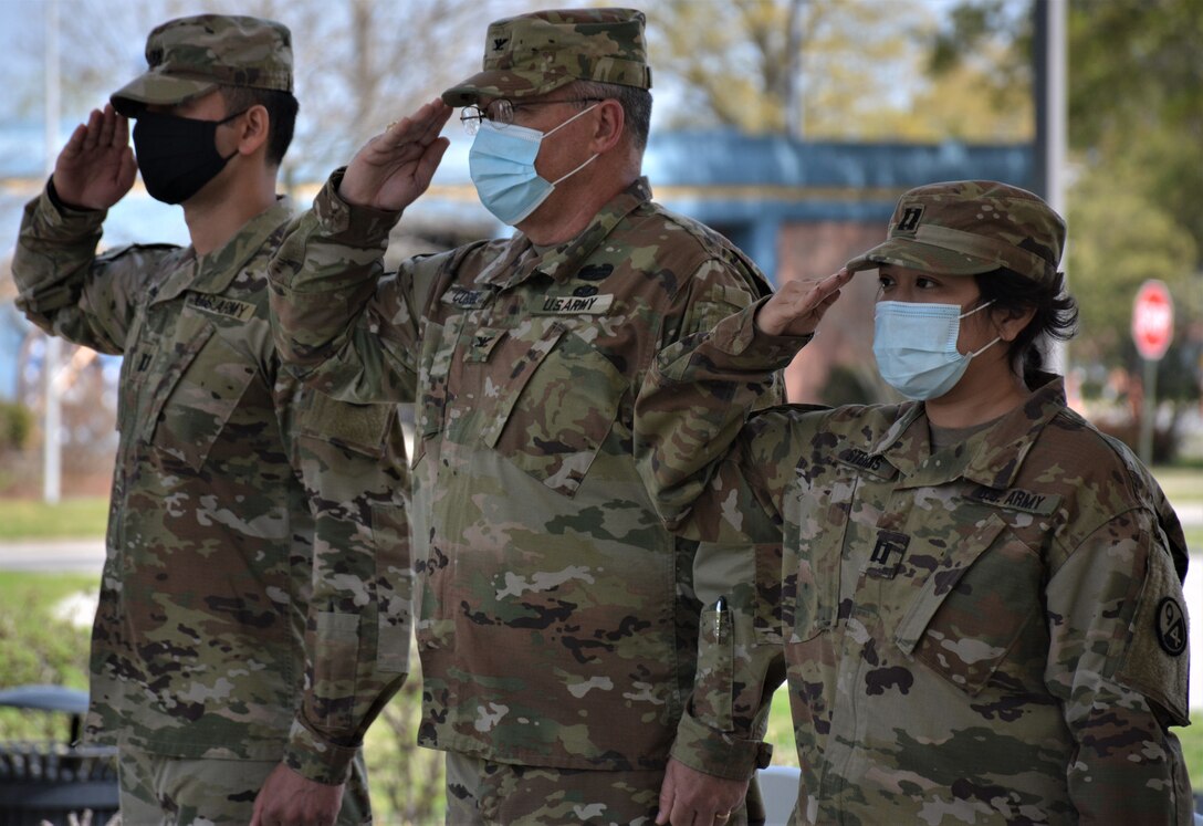 Capt. Alex Singh, outgoing commander (left), Col. Cliffton Cornell, 94th Training Division-Force Sustainment Chief of Staff (center), and Capt. Theang Sterns, incoming commander (right), render a salute during the playing of the National Anthem at the 94th TD-FS Headquarters and Headquarters Company change of command ceremony. The ceremony was held at Fort Lee's Combined Arms Support Command Headquarters to bid farewell to Singh and welcomed Sterns as the 94th TD-FS HHC commander on April 9, 2021. (Photo by Maj. Ebony Gay, 94th TD-FS Public Affairs Office)