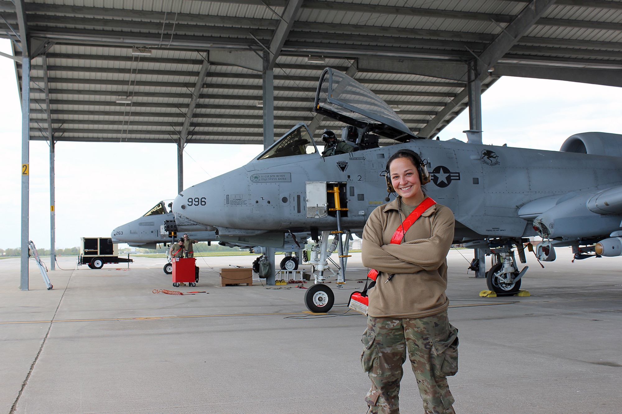 Airman 1st Class Juliann Hammer is seen next to an A-10 Thunderbolt II aircraft at Selfridge Air National Guard Base, Mich., May 16, 2021. Hammer is a crew chief on the A-10. She is also a student at Michigan State University. (U.S. Air National Guard photo by Master Sgt. Dan Heaton)
