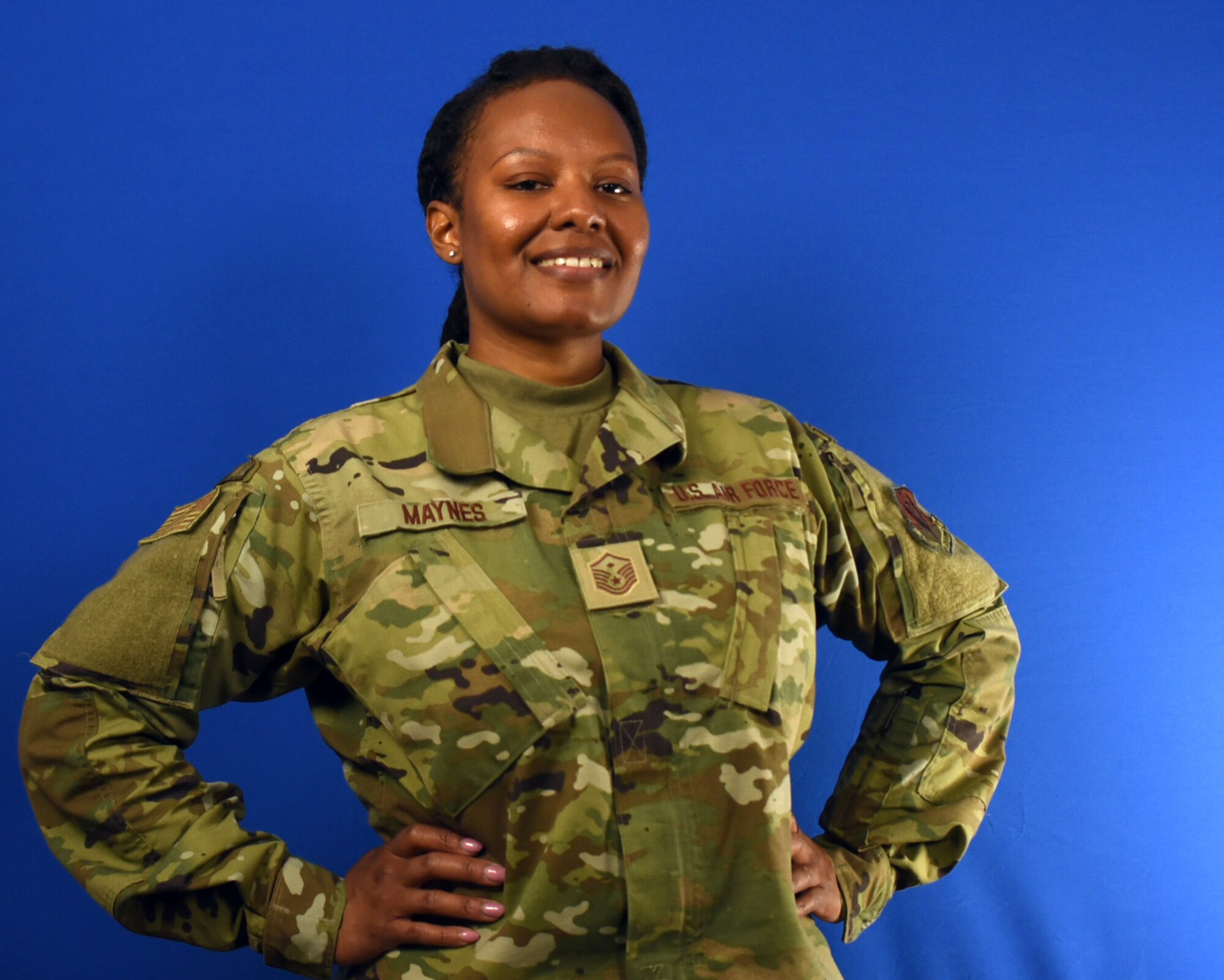 A woman stands with her hands on hips in an Air Force uniform.