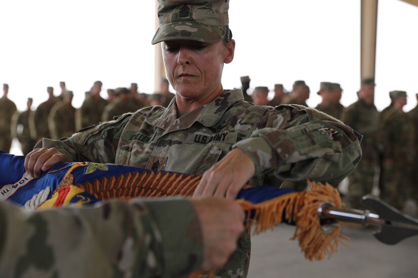 The 2-104th General Support Aviation Battalion's colors are cased during a transfer of authority ceremony. During the ceremony, the 2-104th GSAB formally transferred authority of their mission to the 1-168th GSAB. (U.S. Army photo by Sgt. 1st Class Ryan Sheldon)