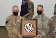 U.S. Army Col. Howard Lloyd, left, commander of the 28th Expeditionary Combat Aviation Brigade, presents a gift to Col. Alan Gronewold, commander of the 40th Combat Aviation Brigade, during a transfer of authority ceremony.