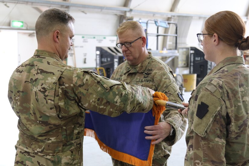 The 1-137th Assault Helicopter Battalion's colors are cased during a transfer of authority ceremony.