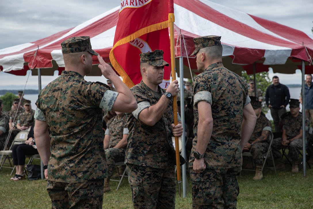 U.S. Marine Corps Lt. Col. Gabriel Diana, a native of Columbus, Ohio and the outgoing commander of 1st Battalion, 2d Marine Regiment (V12), 2d Marine Division, passes the colors to Lt. Col. Aaron Awtry, a native of Midland, Texas and the incoming commander, during a change of command ceremony on Camp Lejeune, N.C., May 13, 2021.