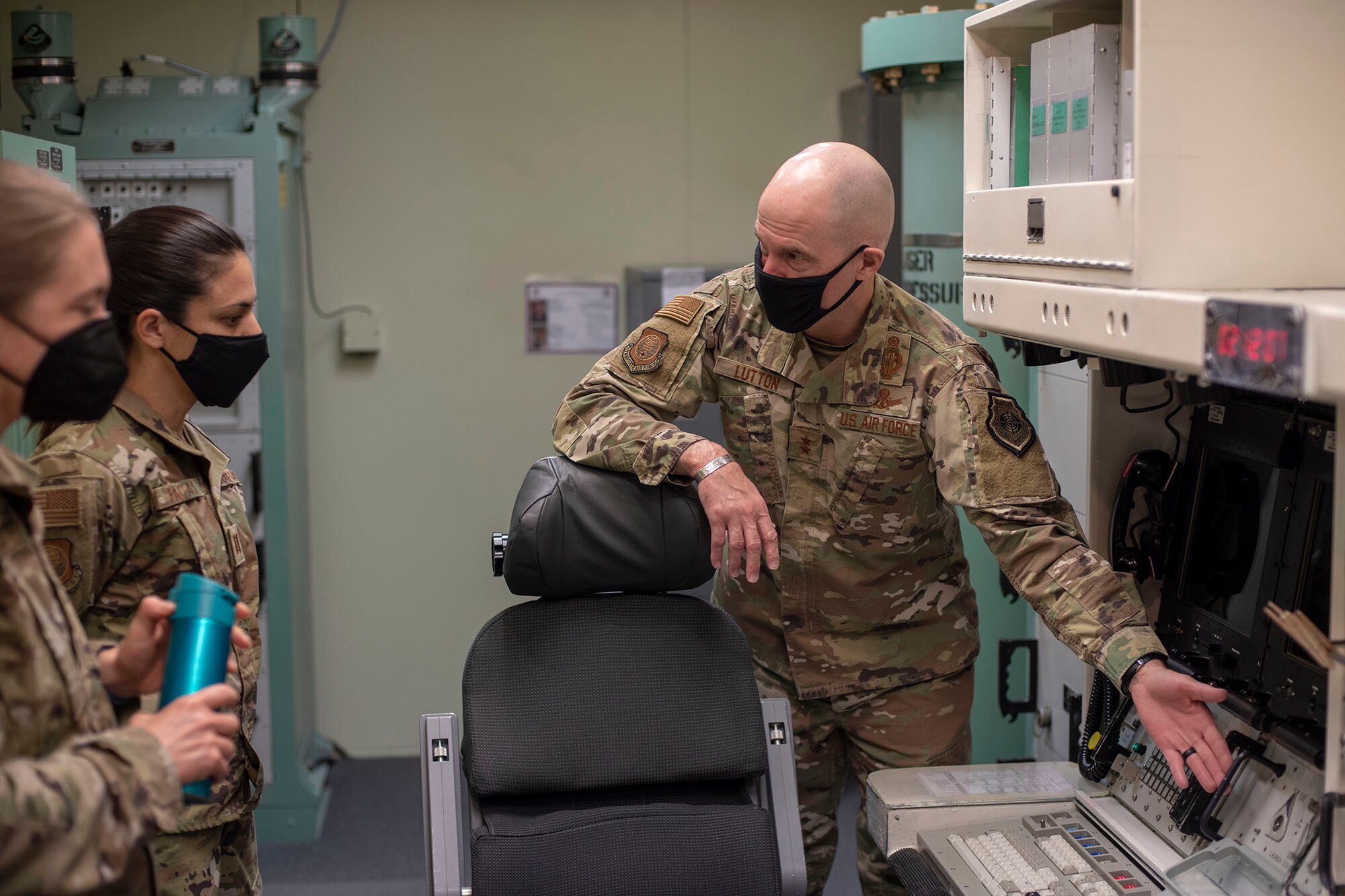 Maj. Gen. Michael J. Lutton, 20th Air Force commander, speaks with Capt. Monica Pacas, executive aide, on functions of the missile procedure trainer May 12, 2021, during his trip to Malmstrom Air Force Base, Mont.