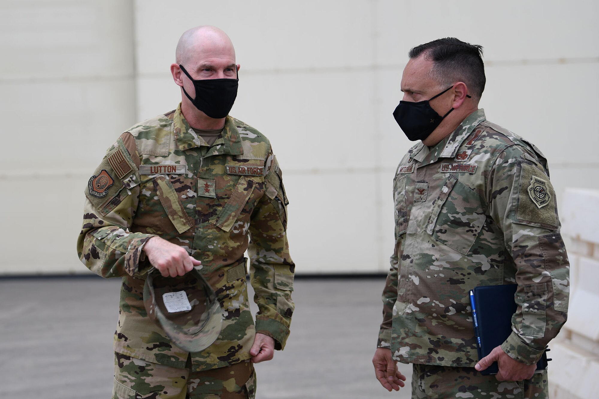 Maj. Gen. Michael J. Lutton, 20th Air Force commander, is greeted by Col. Nathan B. Mitchell, 341st Maintenance Group commander, as he arrives at the maintenance hangar for a tour of the transporter-erector trainer May 10, 2021, at Malmstrom Air Force Base, Mont.