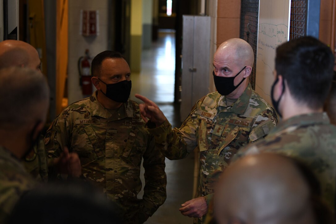 Maj. Gen. Michael J. Lutton, 20th Air Force commander, speaks to Col. Nathan B. Mitchell, 341st Maintenance Group commander, inside of the maintenance hangar May 10, 2021, during his trip to Malmstrom Air Force Base, Mont.