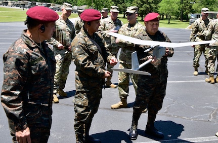 Left to right, Guatemalan Cols. Miguel Orozco, J2 intelligence director; Edgar Agustin, J3 operations director; and Romeo Nerio, training command director; examine an RQ-11 Raven unmanned aircraft operated by the Arkansas National Guard’s 39th Infantry Brigade Combat Team. Maj. Gen. Walfre Carranza, Guatemala’s chief of defense, led a six-person delegation that toured Arkansas National Guard facilities May 13-15, 2021, under the State Partnership Program.