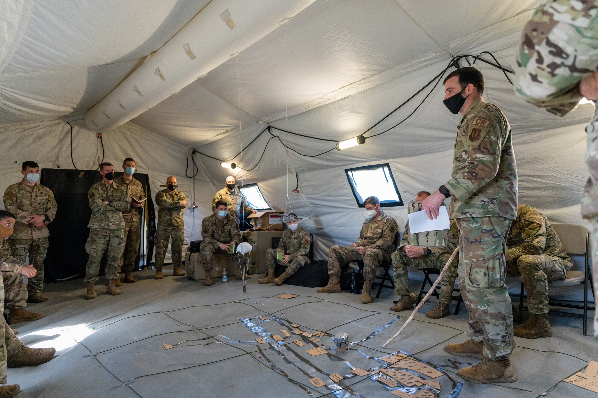 Airmen gathered in a tent.