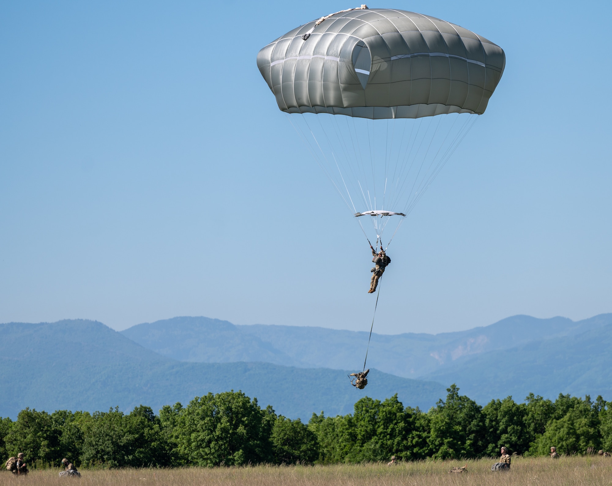 A paratrooper approaching the ground.