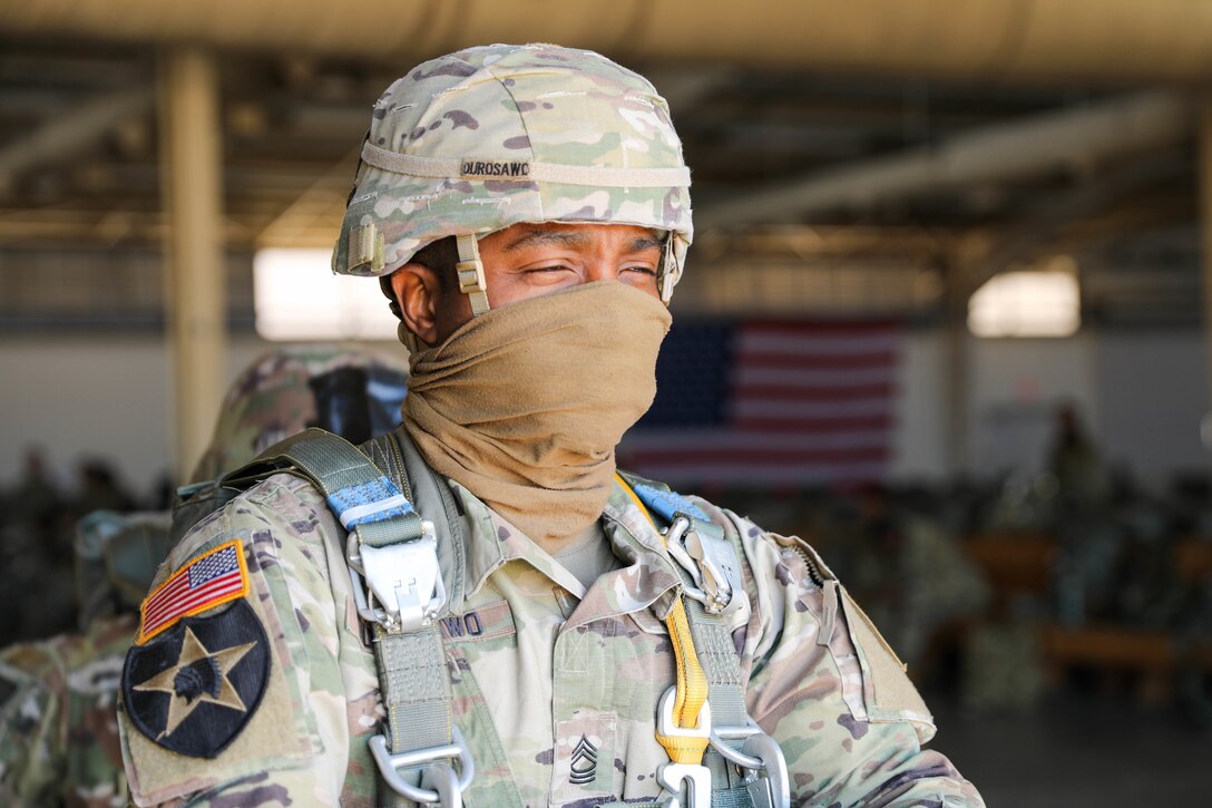 U.S. Army Reserve Master Sgt. Folarin Durosawo, assistant inspector general, U.S. Army Civil Affairs and Psychological Operations Command (Airborne), readies himself for the walk to a U.S. Marine KC-130 aircraft waiting on the tarmac to take to the skies for a tail ramp jump over Sicily Drop Zone, Fort Bragg, N.C., May 1, 2021.