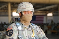 U.S. Army Reserve Master Sgt. Folarin Durosawo, assistant inspector general, U.S. Army Civil Affairs and Psychological Operations Command (Airborne), readies himself for the walk to a U.S. Marine KC-130 aircraft waiting on the tarmac to take to the skies for a tail ramp jump over Sicily Drop Zone, Fort Bragg, N.C., May 1, 2021.