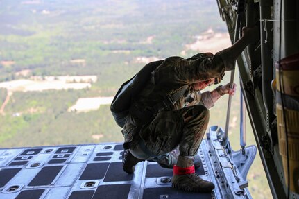 U.S. Army Reserve Maj. Mark Montgomery, jumpmaster and officer in charge of the U.S. Army Civil Affairs and Psychological Operations Command (Airborne) G37, checks for ground hazards upon approach to Sicily Drop Zone, Ft. Bragg, N.C., May 1, 2021. Montgomery was a designated safety for the unit’s jump from the tail ramp of a U.S. Marine KC-130 aircraft.