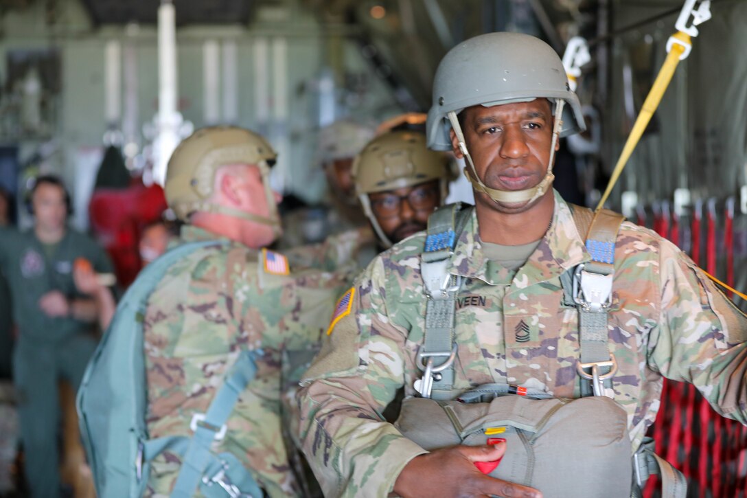 After his final safety inspection, Master Sgt. Lorenzo McElveen, Sr. Human Resource NCO for Headquarters and Headquarters Company, U.S. Army Civil Affairs and Psychological Operations Command (Airborne), waits for a U.S. Marine KC-130 aircraft to enter the Sicily Drop Zone, Ft. Bragg, N.C., on May 1, 2021. McElveen participated in the tail ramp static line jump with his fellow Soldiers during their May battle assembly.