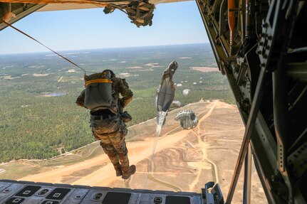 Soldiers from Headquarters and Headquarters Company, U.S. Army Civil Affairs and Psychological Operations Command (Airborne) perform nontactical airborne operations utilizing T-10C parachutes and their own skills and training as they exit a U.S. Marine KC-130 during a static line jump over Sicily Drop Zone, Ft. Bragg, N.C., May 1, 2021. The tail ramp jump allowed Soldiers the opportunity to refresh their skills and update their jump qualifications.