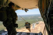 Soldiers from Headquarters and Headquarters Company, U.S. Army Civil Affairs and Psychological Operations Command (Airborne) join their fellow paratroopers in the air as they exit a U.S. Marine KC-130 aircraft during a static line jump over Sicily Drop Zone, Ft. Bragg, N.C., May 1, 2021. The tail ramp jump allowed Soldiers the opportunity to refresh their skills and update their jump qualifications.