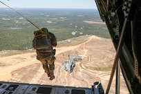 Waiting for that last pull of the deploying chute, a final Headquarters and Headquarters Company, U.S. Civil Affairs and Psychological Operations Command (Airborne) Soldier exits a U.S. Marine KC-130 aircraft during a static line jump over Sicily Drop Zone, Ft. Bragg, N.C., May 1, 2021. The tail ramp jump allowed Soldiers the opportunity to refresh their skills and update their jump qualifications.