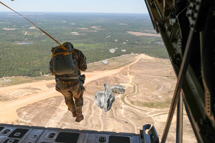 Waiting for that last pull of the deploying chute, a final Headquarters and Headquarters Company, U.S. Civil Affairs and Psychological Operations Command (Airborne) Soldier exits a U.S. Marine KC-130 aircraft during a static line jump over Sicily Drop Zone, Ft. Bragg, N.C., May 1, 2021. The tail ramp jump allowed Soldiers the opportunity to refresh their skills and update their jump qualifications.