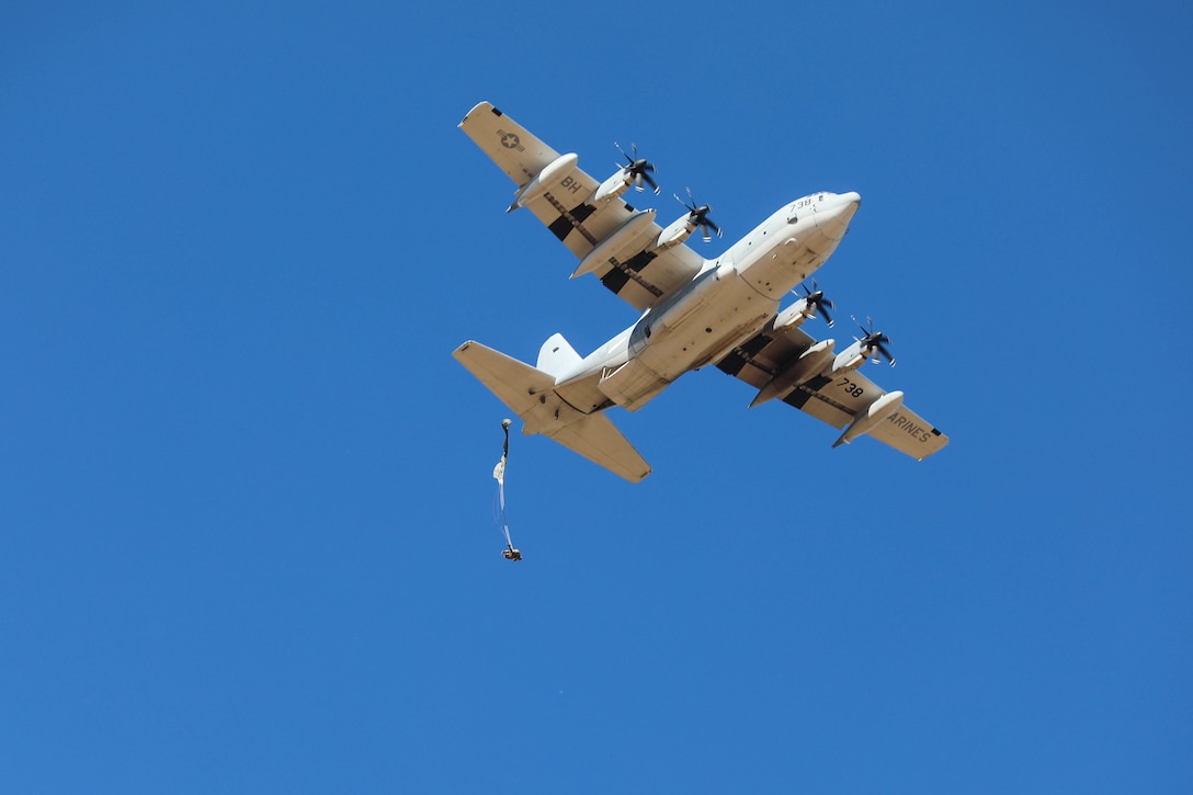 Jumpers out! The first of many Headquarters and Headquarters Company Soldiers from the U.S. Army Civil Affairs and Psychological Operations Command (Airborne) exits a U.S. Marine KC-130 aircraft circling the Sicily Drop Zone, Fort Bragg, N.C.,, May 1, 2021. The HHC Soldiers were completing a tail ramp jump to refresh skills and maintain jump qualification and readiness status.