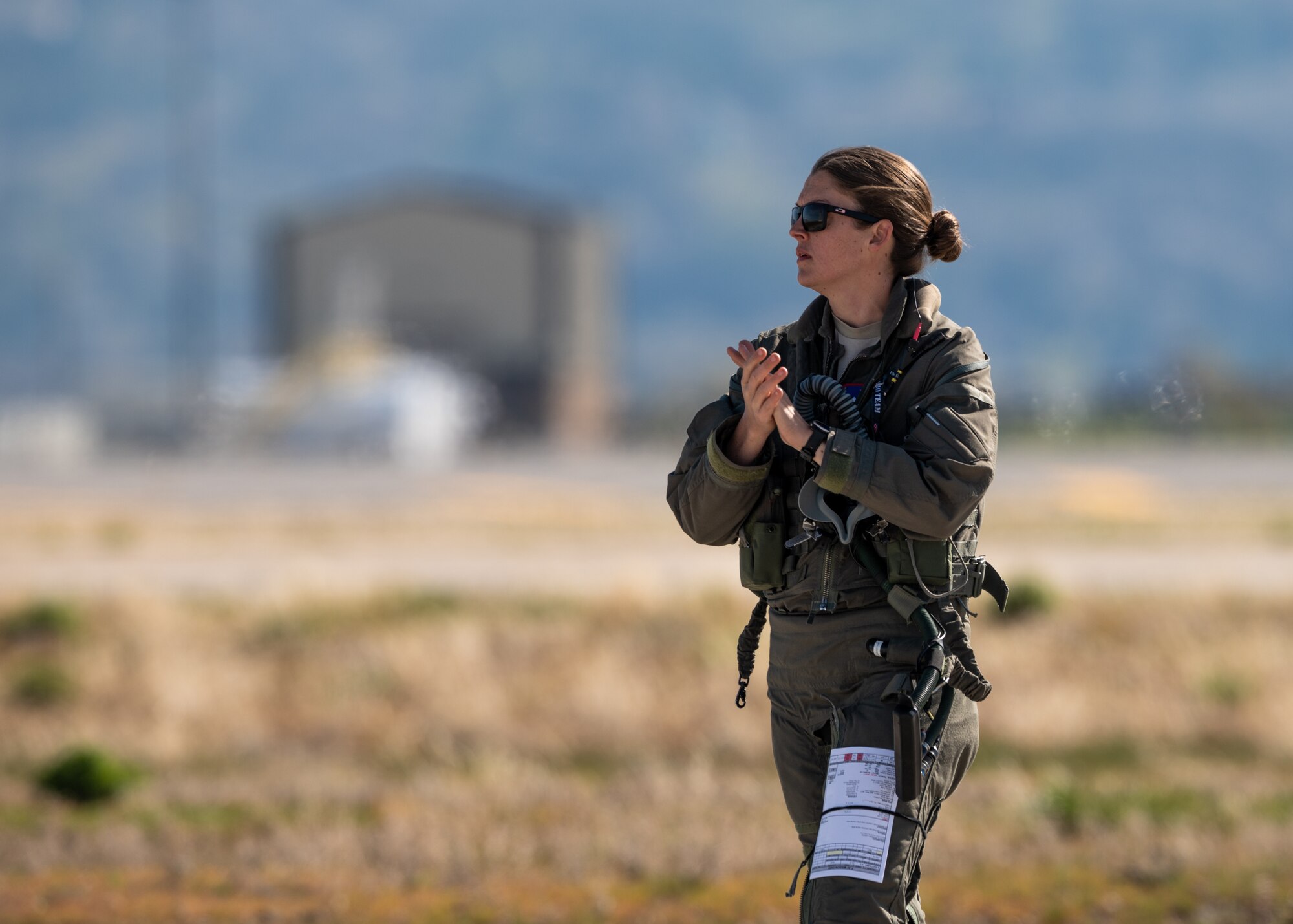 A female pilot walks across a runway