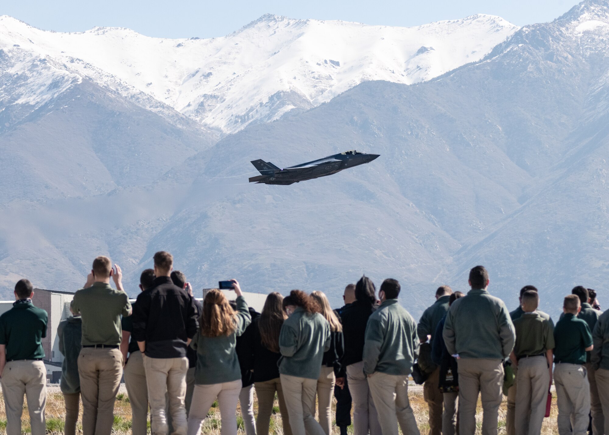 High School Students watch an F-35A Fighter jet fly