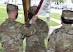 Capt. Chris Wright, center, accepts the colors from Col. John “Ryan” Bailey as he becomes the new commander of the U.S. Army Medical Materiel Agency Detachment during a change of command ceremony May 13 at Fort Detrick, Maryland. Looking on is outgoing commander, Maj. Ivette Daley.