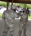 Maj. Ivette Daley elbow bumps Col. Clayton Carr following the U.S. Army Medical Materiel Agency Detachment’s change of command ceremony May 13 at Fort Detrick, Maryland. Daley, the outgoing detachment commander, departs the organization after two years for her new assignment at Fort Carson, Colorado.
