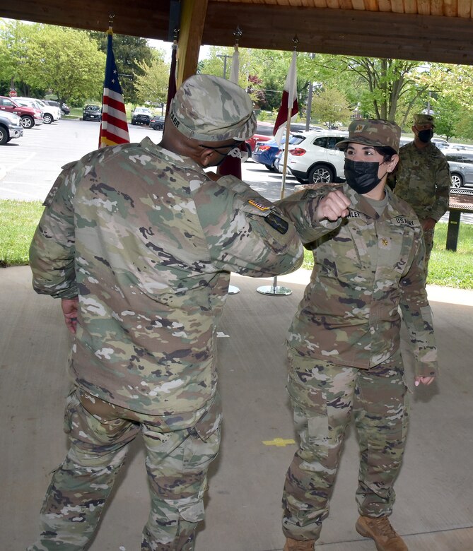 Maj. Ivette Daley elbow bumps Col. Clayton Carr following the U.S. Army Medical Materiel Agency Detachment’s change of command ceremony May 13 at Fort Detrick, Maryland. Daley, the outgoing detachment commander, departs the organization after two years for her new assignment at Fort Carson, Colorado.