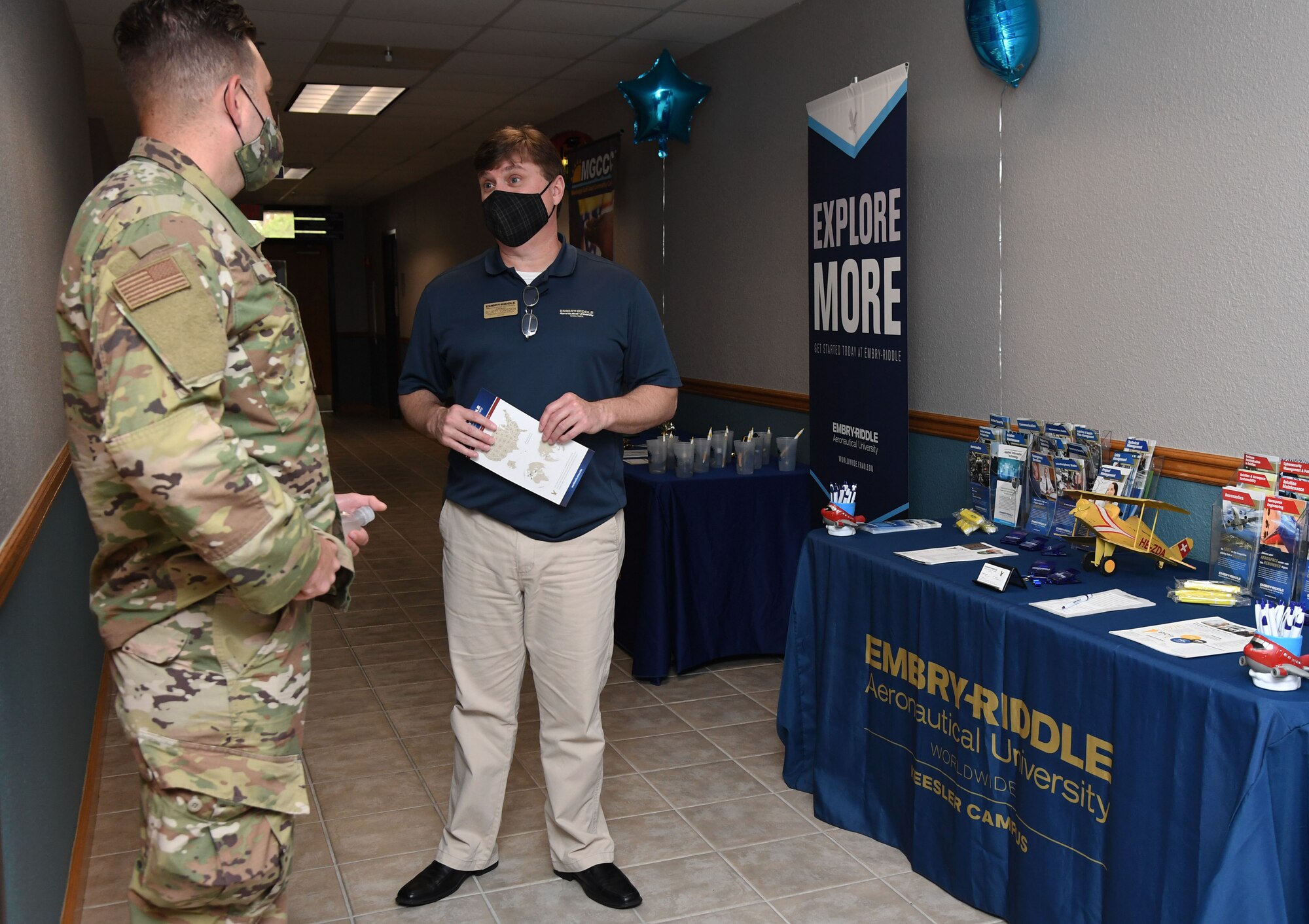 U.S. Air Force Staff Sgt. Troy Tucker, 81st Logistics Readiness Squadron vehicle management supervisor, and Elliott Voivedich, Embry-Riddle Aeronautical University associate campus director, discuss education opportunities during the National Test Center reopening ceremony inside the Sablich Center at Keesler Air Force Base, Mississippi, May 12, 2021. After being closed for over a year, the center, which is managed by Bellevue University, offers free CLEP and DANTES Subject Standardized Test exams to military members. (U.S. Air Force photo by Kemberly Groue)