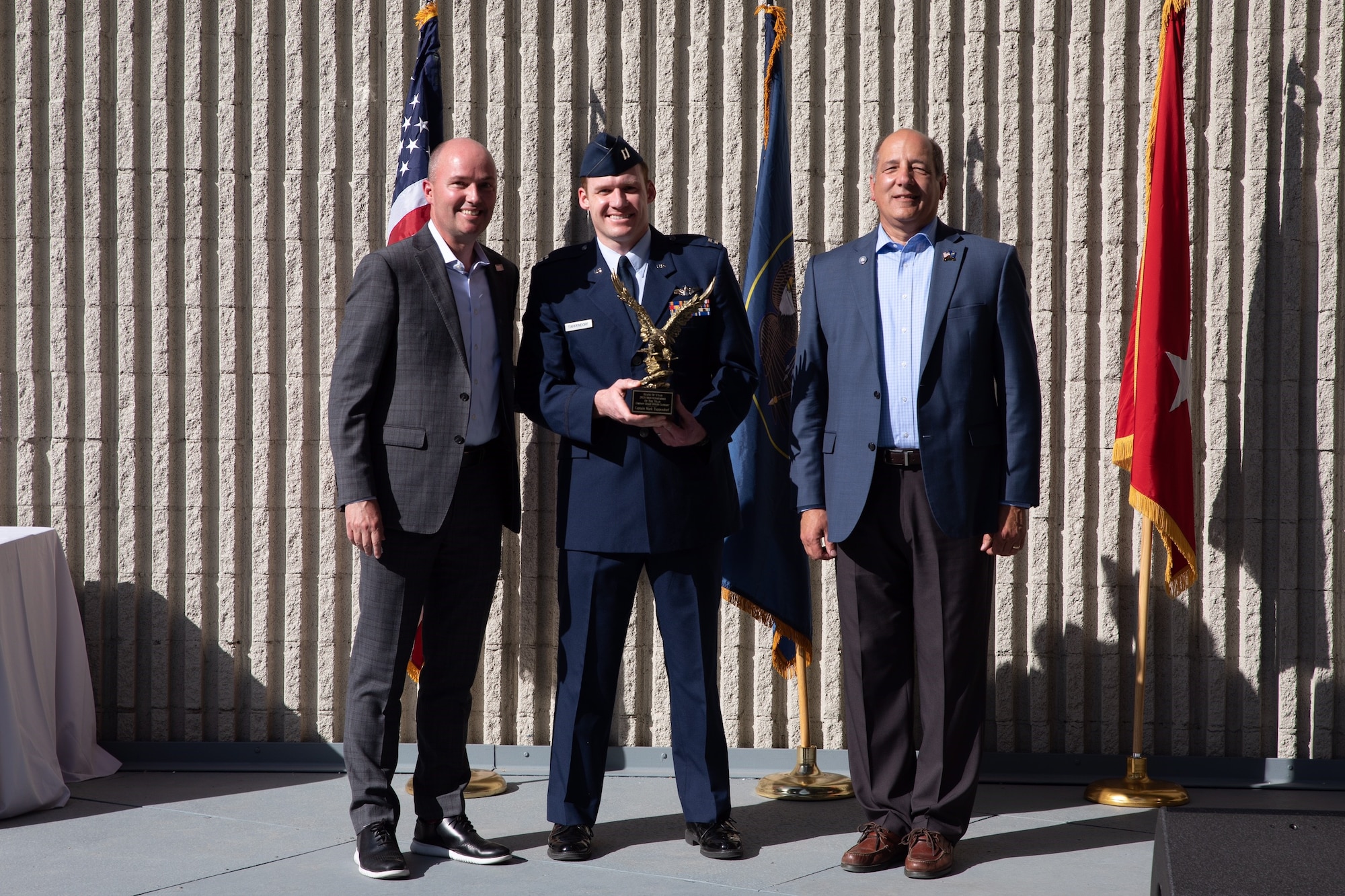 Capt. Mark Tappendorf, reservist in the 419th Fighter Wing, accepts Utah's Company Grade Officer of the Year award from Gov Spencer Cox and Gary Harter, executive director of Utah's Department of Veteran and Military Affairs during a ceremony May 15 in Murray, Utah.