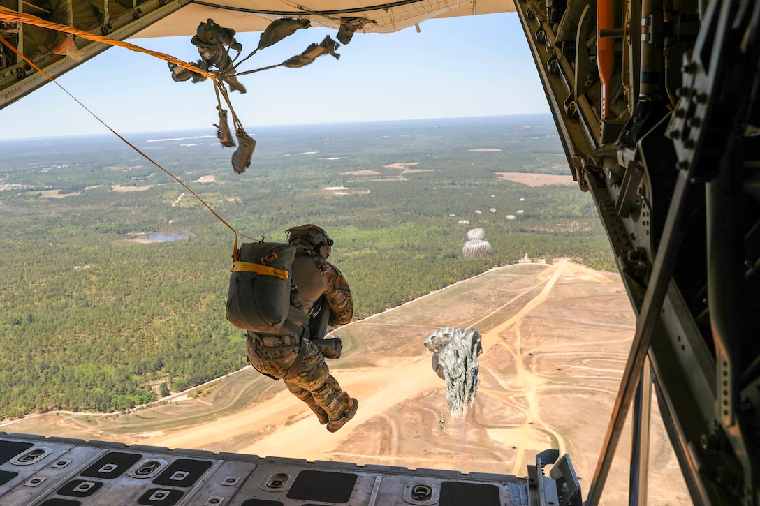 A soldier jumps out of an aircraft.