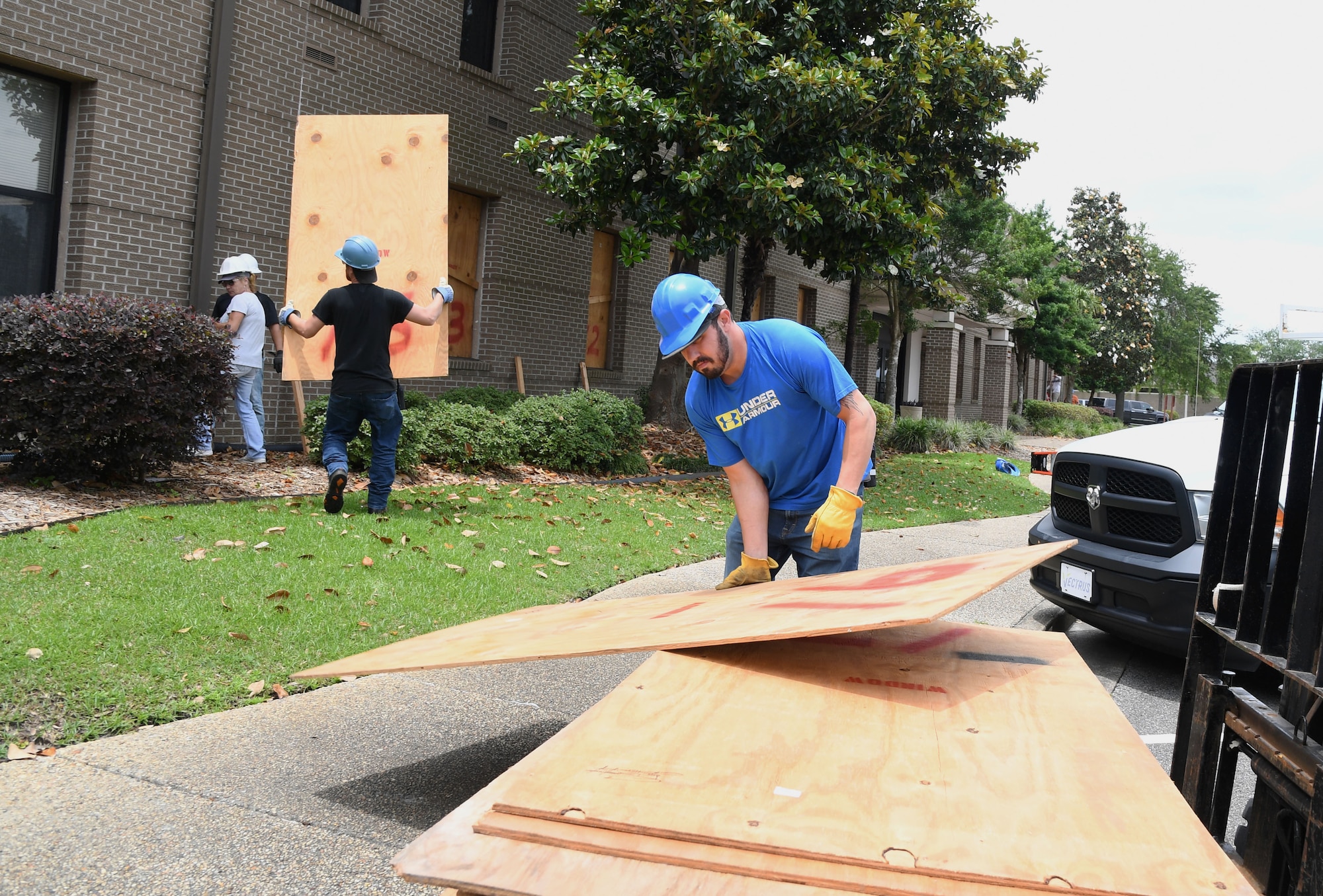 Chad Jacquet, Vectrus carpenter, unloads boarding materials in front of the 81st Training Wing headquarters building during a hurricane exercise at Keesler Air Force Base, Mississippi, May 12, 2021. Keesler personnel participate in exercise scenarios in preparation for hurricane season. (U.S. Air Force photo by Kemberly Groue)