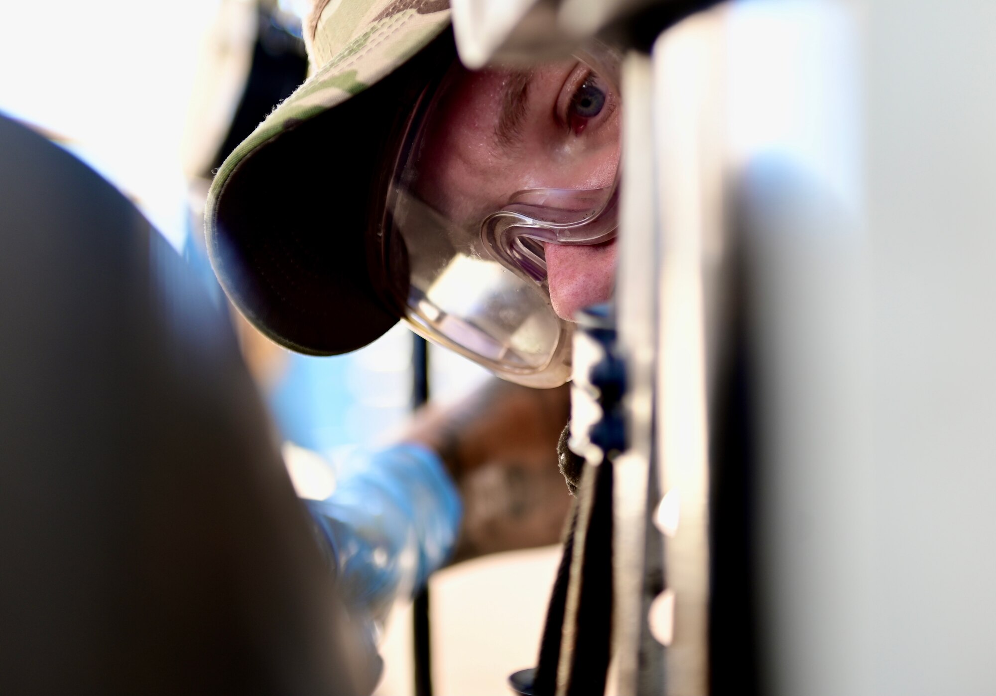 close up photo of an airman performing maintenance on an A-10 Thunderbolt II aircraft tire