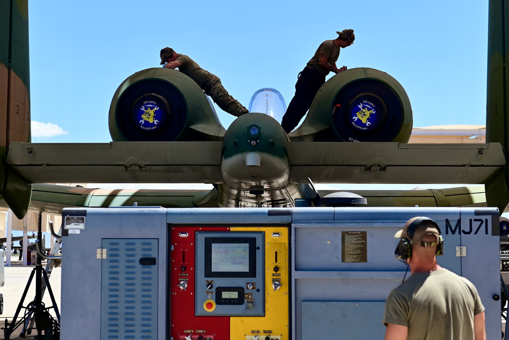 photo of airmen performing maintenance on an A-10 Thunderbolt II aircraft