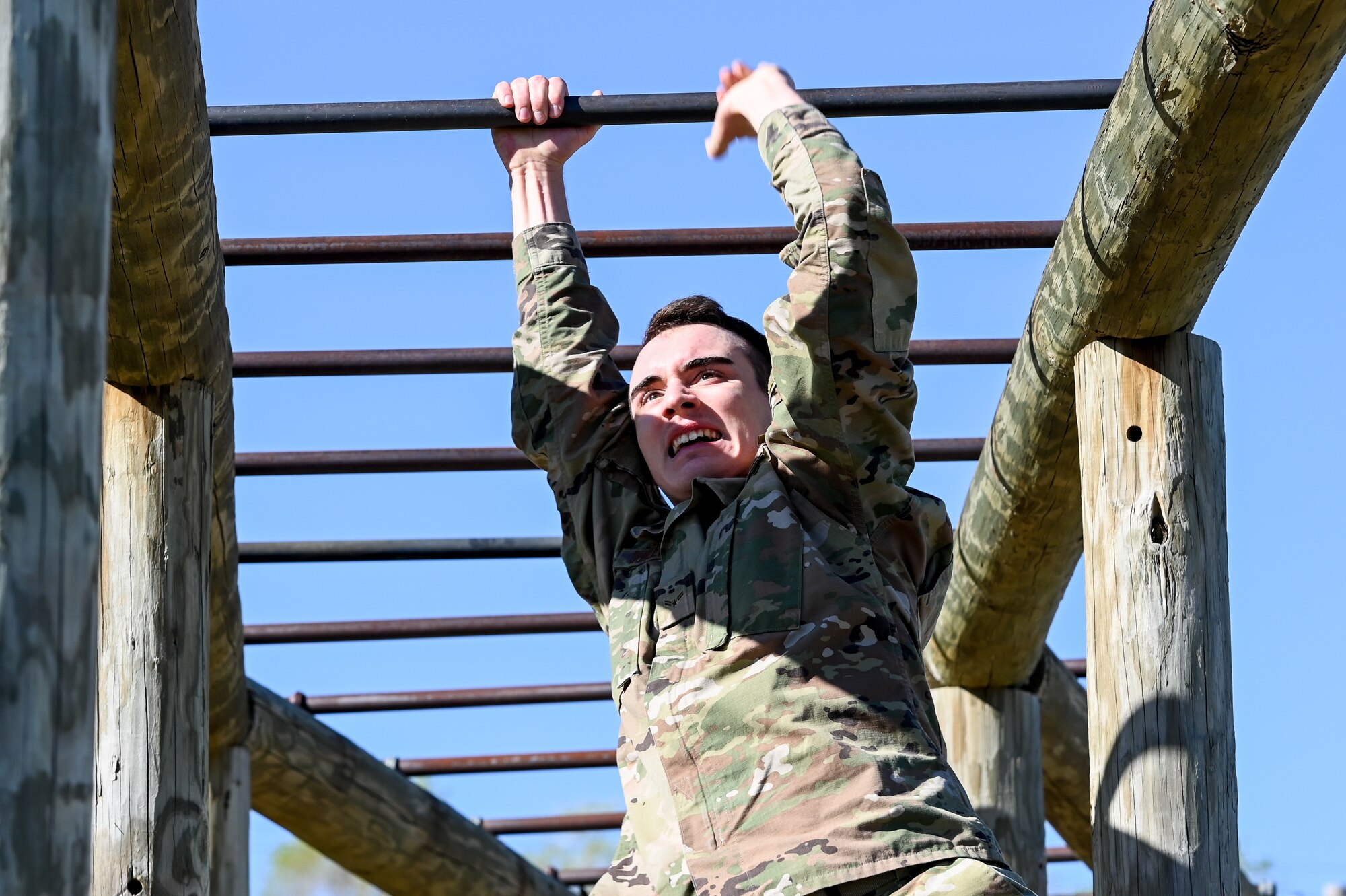 Airman 1st Class Justin Dunlevy, 75th Security Forces Squadron, runs through the monkey bars in the National Police Week obstacle course competition May 11, 2021, at Hill Air Force Base, Utah. The obstacle course competition was one of many events 75th SFS hosted to commemorate the week to honor the sacrifices of the law enforcement community. (U.S. Air Force photo by Cynthia Griggs)