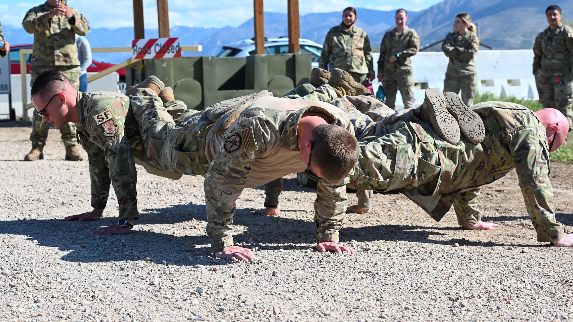 The non-commissioned officer team from the 75th Security Forces Squadron do a four-man push-up during the National Police Week obstacle course competition May 11, 2021, at Hill Air Force Base, Utah. The obstacle course competition was one of many events 75th SFS hosted to commemorate the week to honor the sacrifices of the law enforcement community. (U.S. Air Force photo by Cynthia Griggs)