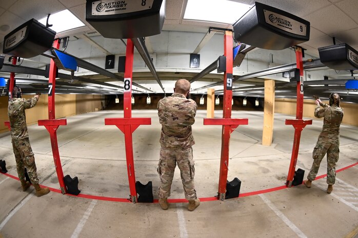 Airmen participate in the National Police Week pistol shooting competition May 13, 2021, at Hill Air Force Base, Utah. The competition included one-handed shooting and was one of many events 75th Security Forces Squadron hosted to commemorate the week to honor the sacrifices of the law enforcement community. (U.S. Air Force photo by Cynthia Griggs)
