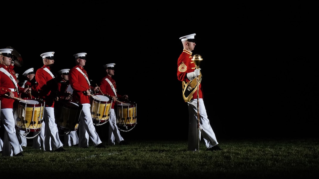 Master Sgt. Joshua Dannemiller, assistant drum major, U.S. Marine Drum and Bugle Corps, leads “The Commandant’s Own,” during “slow march” at the Friday Evening Parade at Marine Barracks Washington, D.C., May 14, 2021. The Deputy Commandant for Combat Development and Integration and Commanding General of Marine Corps Combat Development Command Lt. Gen. Eric M. Smith, was the hosting official, and the guests of honor were the 12th NASA Administrator the Honorable Charles F. Bolden, Jr., Maj. Gen., USMC (Ret.); NASA Astronaut and active duty Marine Lt. Col. Nicole A. Man; and NASA Astronaut and active duty Marine Maj. Jasmin Moghbeli. (U.S. Marine Corps photo by Sgt. Jason Kolela)