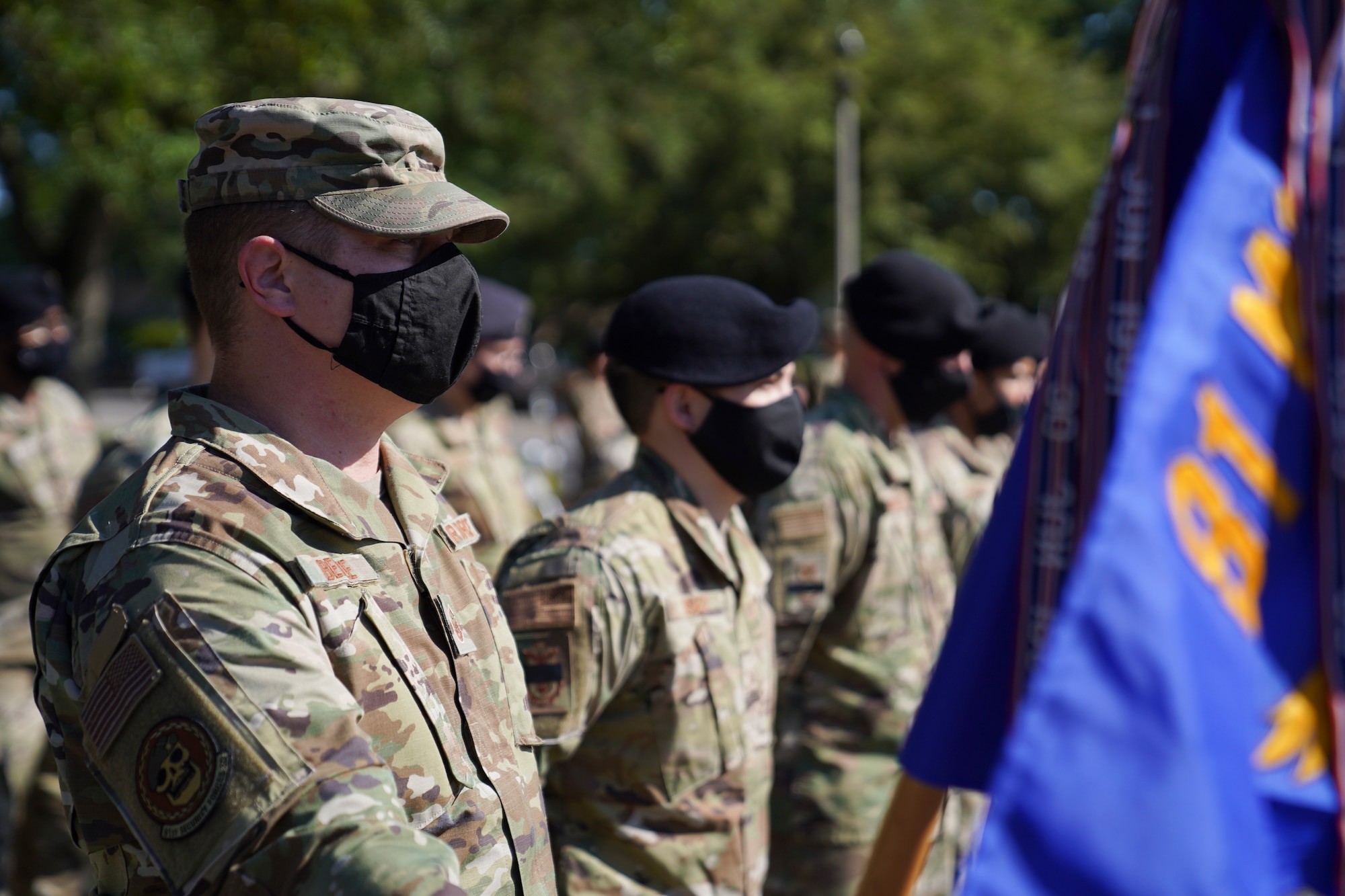 U.S. Air Force Master Sgt. Branden Behee, 81st Security Forces Squadron first sergeant, holds the guidon during the Police Week retreat ceremony at Keesler Air Force Base, Mississippi, May 14, 2021. The event was held during National Police Week, recognizing the men and women in law enforcement. (U.S. Air Force photo by Senior Airman Spencer Tobler)