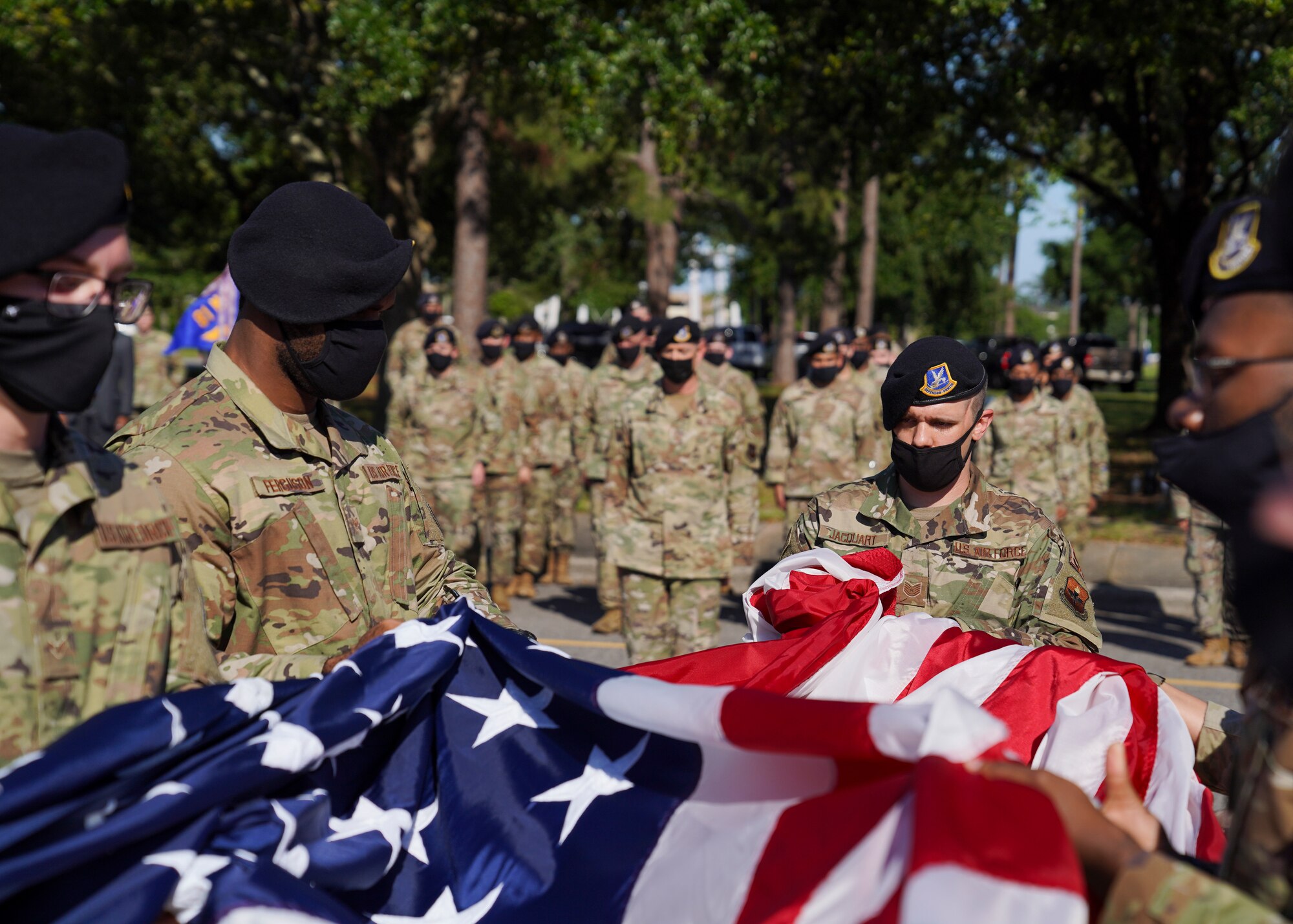 Airmen from the 81st Security Forces Squadron, fold the U.S. flag during the Police Week retreat ceremony at Keesler Air Force Base, Mississippi, May 14, 2021. The event was held during National Police Week, recognizing the men and women in law enforcement. (U.S. Air Force photo by Senior Airman Spencer Tobler)