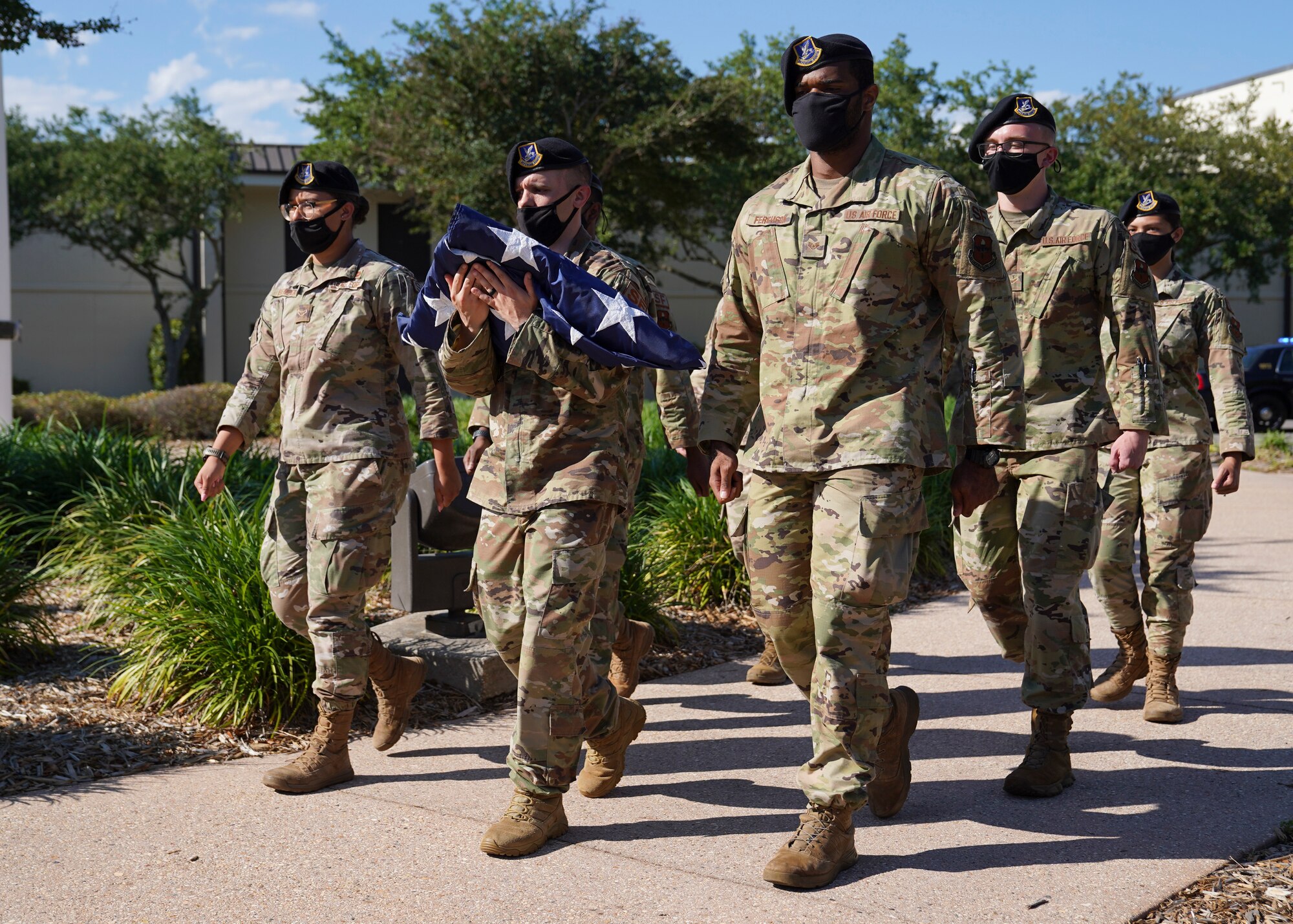 Airmen from the 81st Security Forces Squadron, carry the U.S. flag during the Police Week retreat ceremony at Keesler Air Force Base, Mississippi, May 14, 2021. The event was held during National Police Week, recognizing the men and women in law enforcement. (U.S. Air Force photo by Senior Airman Spencer Tobler)