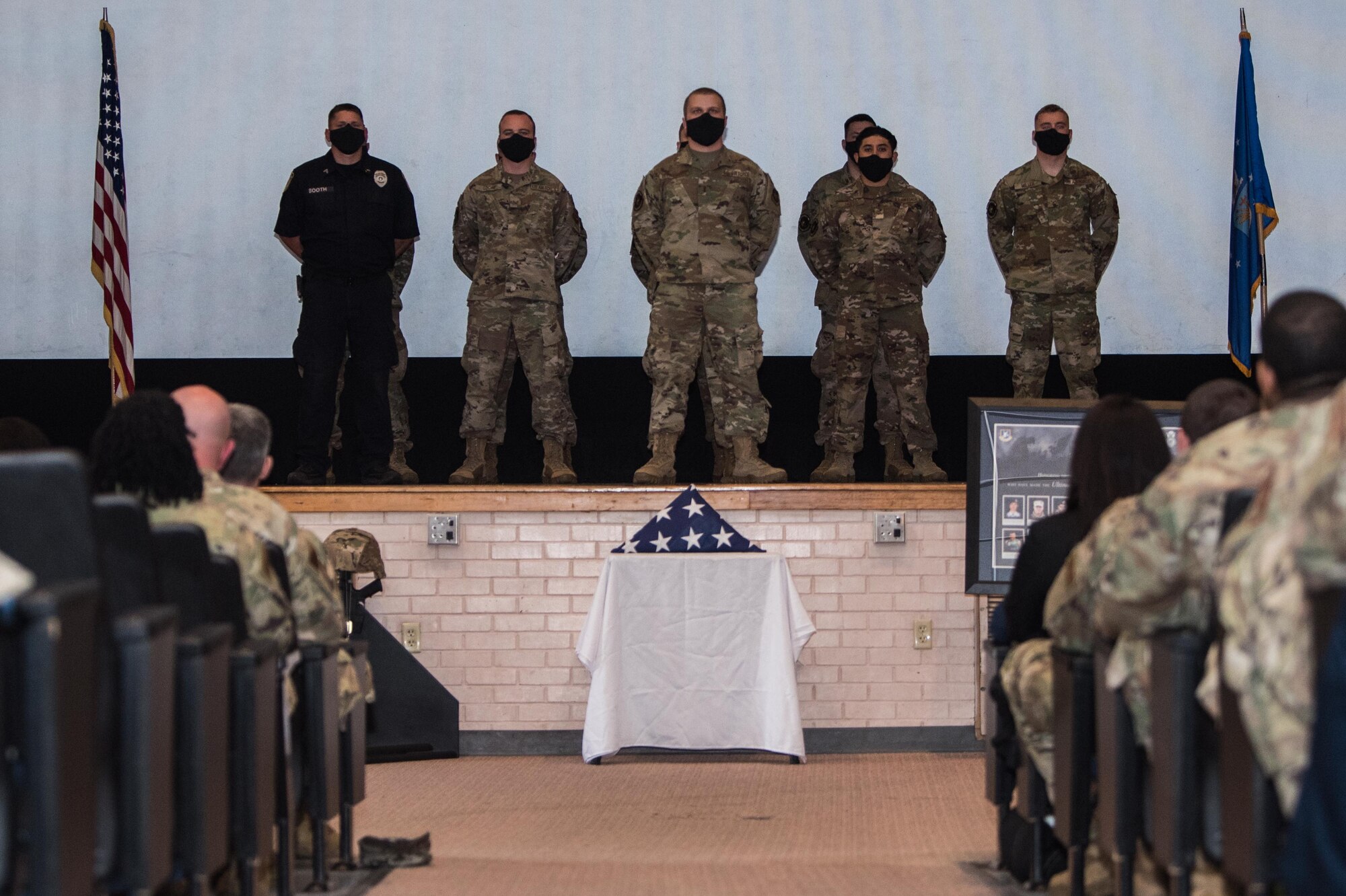 Members of the 22nd Security Forces Squadron stand in formation during a National Police Week Guard Mount ceremony May 14, 2021, at McConnell Air Force Base, Kansas. National Police Week is recognized every year in May to honor those that have sacrificed their lives protecting their communities. (U.S. Air Force photo by Senior Airman Alexi Bosarge)