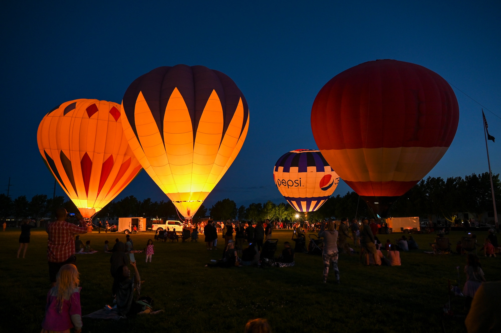 Hot air balloons light up the evening sky