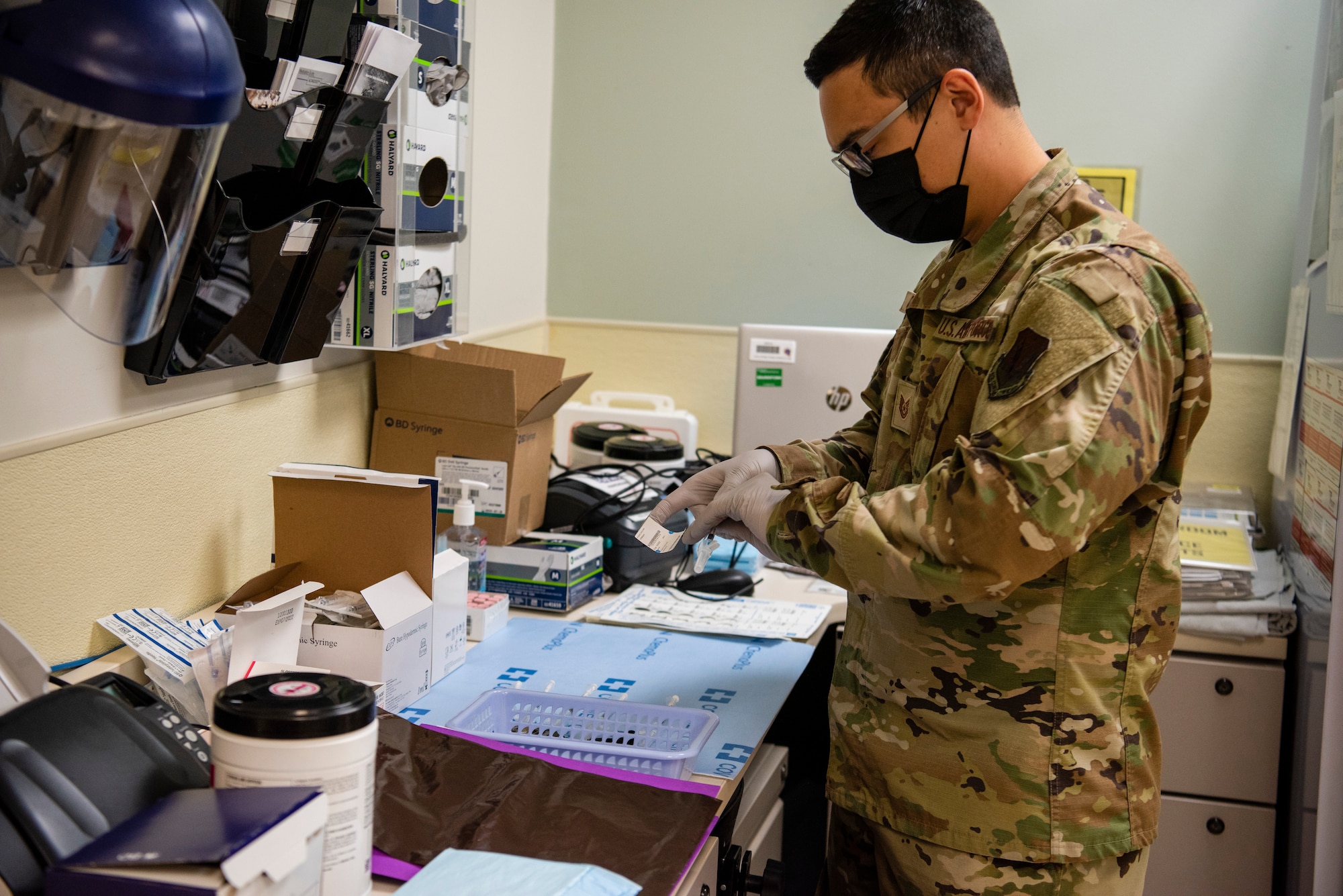 Tech. Sgt. Jaymes prepares COVID-19 vaccines to administered by medical personnel.
