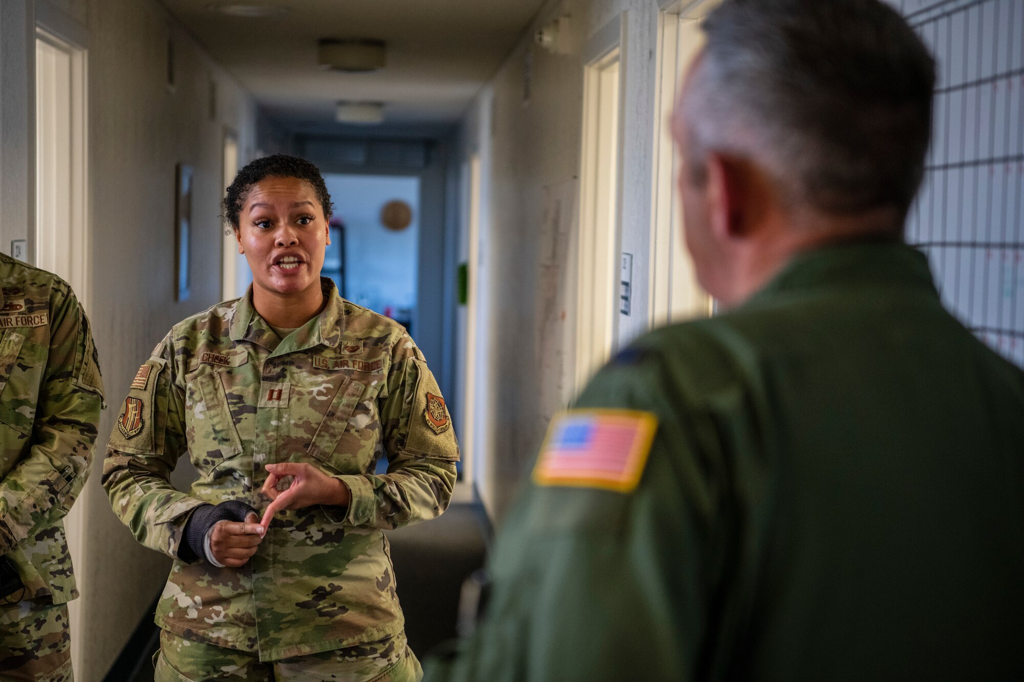 A female Airman briefs base leadership.