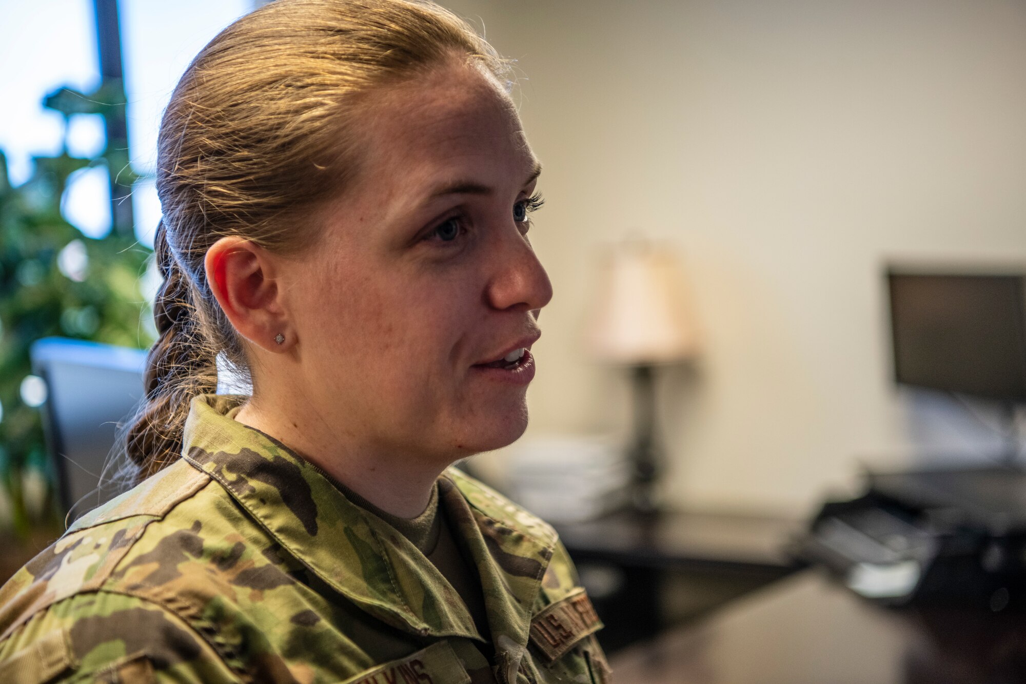An Airman's portrait is taken while she briefs base leadership.