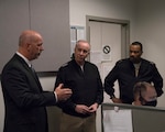 Vice Chief of Naval Operations, Adm. Bill K. Lescher speaks with Program Analyst Tim Hunter, and Commander, Navy Personnel Command, Rear Adm. Alvin Holsey, during a tour of the MyNavy Career Center (MNCC) at Navy Personnel Command (NPC), May 17.