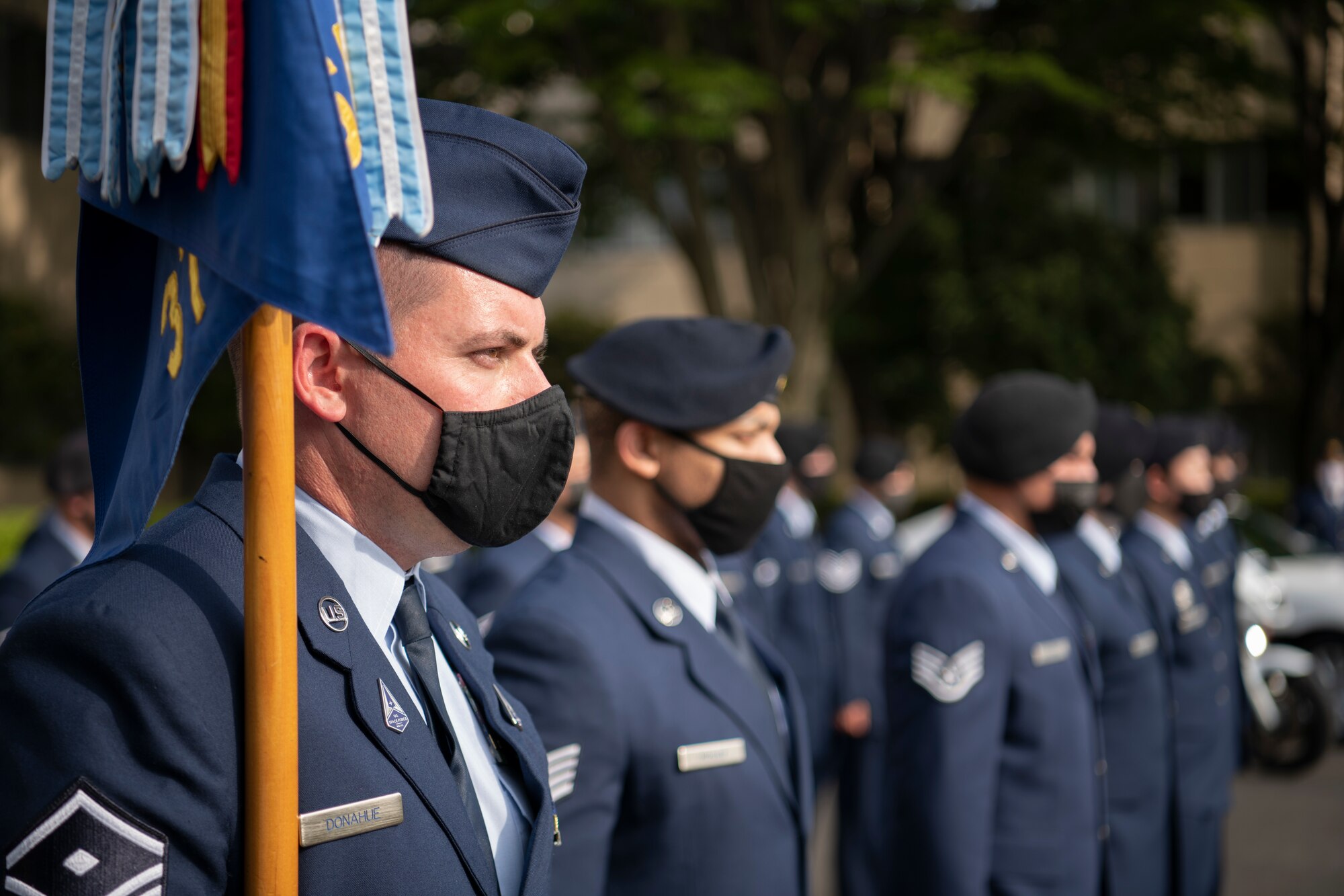 Master Sgt. Joshua Donahue, 374th Security Forces Squadron first sergeant, holds a guidon for a formation at the National Police Week retreat ceremony at Yokota Air Base, Japan, May 14, 2021. The retreat ceremony was the end of National Police Week activities for the base. (U.S. Air Force photo by Staff Sgt. Braden Anderson)