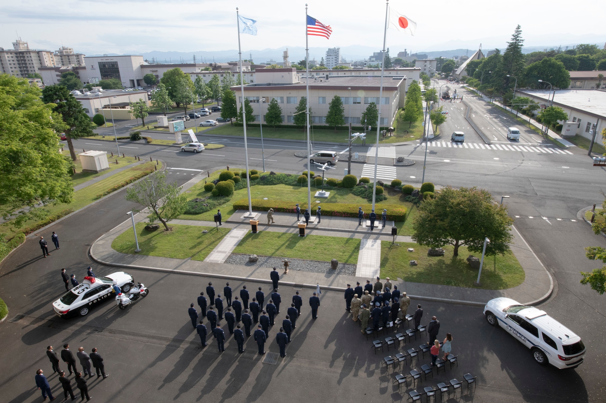 The base honor guard prepares to lower the American and Japanese flags during the National Police Week retreat ceremony at Yokota Air Base, Japan, May 14, 2021. Police Week is a week-long event to honor police officers and is recognized overseas with security forces members. (U.S. Air Force photo by Staff Sgt. Ryann Holzapfel)